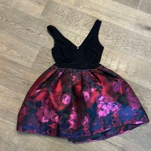 Stunning mini sleeveless dress with tulle skirt and sheer cutouts.